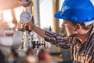 man checking gas meter