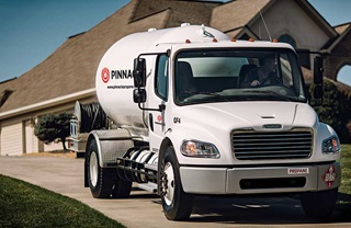 Propane bobtail truck in front of house